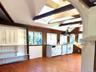 Kitchen with white cabinetry, white appliances, island exhaust hood, light wood finished floors, and a skylight