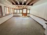 Empty room featuring beam ceiling and tile patterned flooring