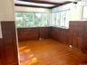 Spare room featuring light wood-style flooring and beam ceiling
