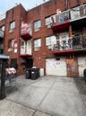 View of apartment building / complex with driveway