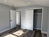 bedroom with dark wood-style floors, recessed lighting, and a closet