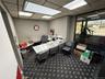 Carpeted office featuring a drop ceiling