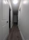 Corridor with baseboards and wood finished floors
