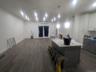 Kitchen featuring gray cabinetry, white cabinets, dark wood-style flooring, and hanging light fixtures
