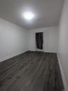 Unfurnished bedroom featuring baseboards and dark wood-type flooring
