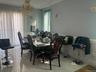 Dining room with wainscoting, a chandelier, and a decorative wall