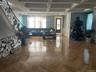 Living room featuring coffered ceiling, a chandelier, and beam ceiling
