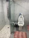 Bathroom with tile walls and a marble finish shower
