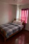 Bedroom featuring wood-type flooring and baseboards