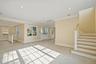 Unfurnished living room featuring stairway, recessed lighting, plenty of natural light, and ornamental molding