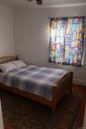 Bedroom with dark wood-type flooring
