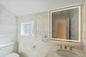 Bathroom with vanity and tile walls