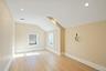 Spare room with vaulted ceiling, light wood-style floors, and recessed lighting