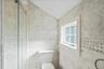 Bathroom with a stall shower and lofted ceiling