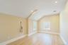 Empty room with lofted ceiling, light wood-style floors, and recessed lighting