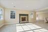 Unfurnished living room featuring ornamental molding, a fireplace, and recessed lighting