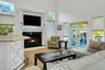 Living area with french doors, a towering ceiling, and a premium fireplace