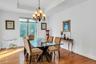 Dining area featuring hardwood / wood-style flooring, a chandelier, and a tray ceiling