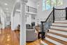 Living area with light wood-style floors, stairway, a high ceiling, recessed lighting, and decorative columns