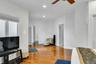 Living area featuring light wood finished floors, recessed lighting, and a ceiling fan