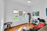 Home office with light wood-style floors and ceiling fan