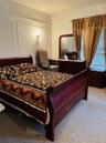 Bedroom featuring a decorative wall and carpet floors
