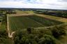 Aerial view of property's location featuring rural landscape and extensive farmland