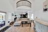 Living room featuring a high ceiling and light tile patterned flooring