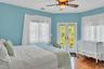 Bedroom with hardwood / wood-style flooring, access to exterior, a ceiling fan, and french doors