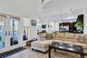 Living room featuring french doors, recessed lighting, a high ceiling, and light tile patterned floors