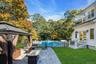 View of yard featuring a patio, a balcony, a gazebo, a fire pit, and view of wooded area