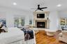 Bedroom featuring multiple windows, wood finished floors, access to exterior, a ceiling fan, and recessed lighting