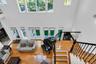 Living room with a high ceiling, french doors, hardwood / wood-style floors, and stairs