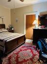 Bedroom with a textured ceiling and a ceiling fan