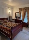 Carpeted bedroom with a decorative wall