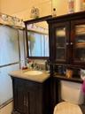 Bathroom with vanity and enclosed tub / shower combo
