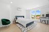 Bedroom with light wood-type flooring, a wall unit AC, and recessed lighting