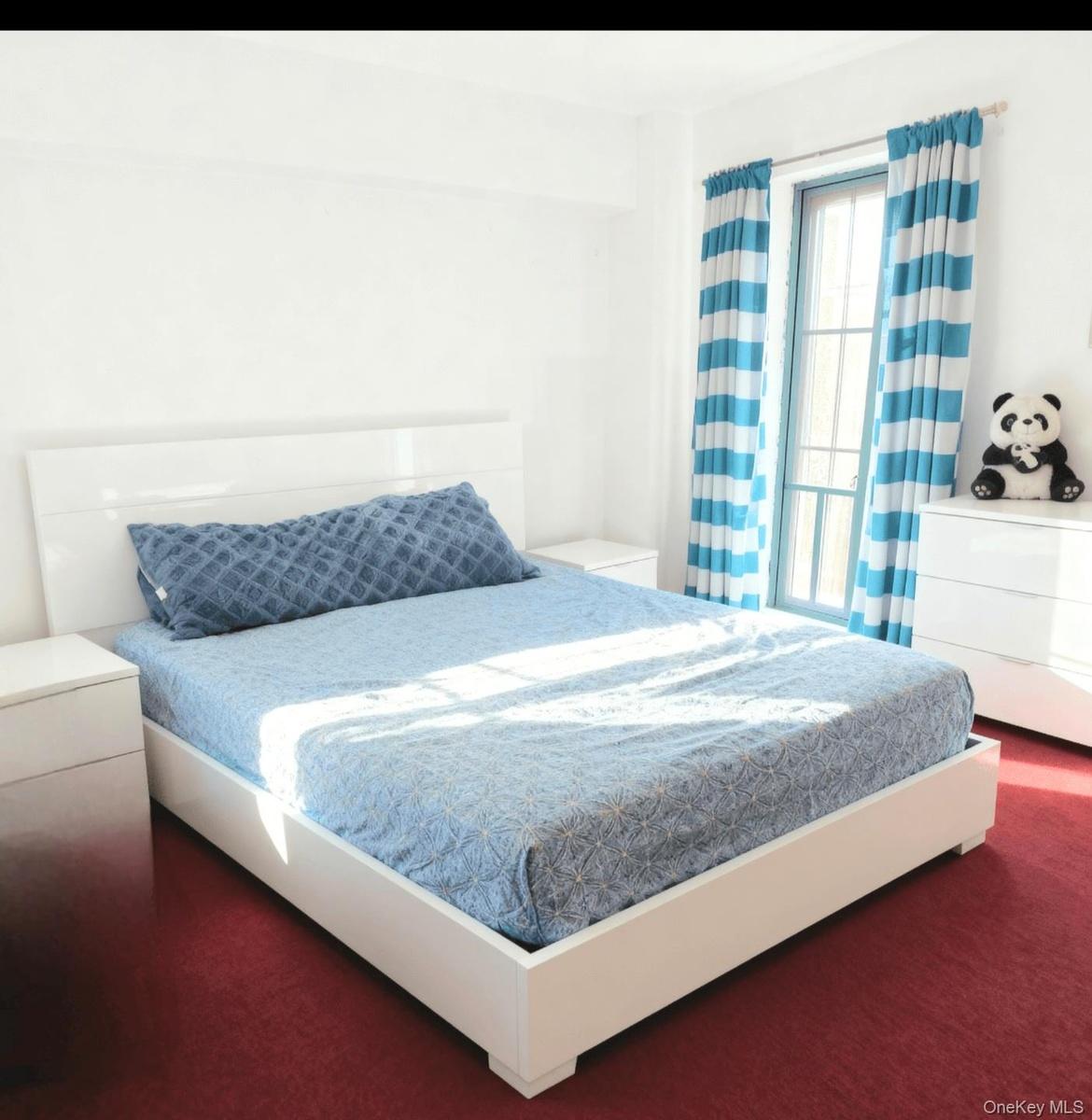 Bedroom featuring dark colored carpet