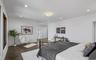 Bedroom with dark wood finished floors and recessed lighting