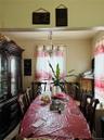 Dining area featuring tile patterned floors and a chandelier