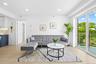 Living room with light wood-style flooring and recessed lighting