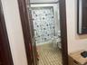 Full bathroom featuring vanity, shower / bath combo, and light tile patterned floors