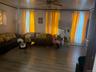 Living area with wood finished floors and a ceiling fan