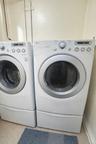 Laundry area featuring washing machine and clothes dryer and baseboards