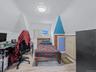 Bedroom featuring lofted ceiling