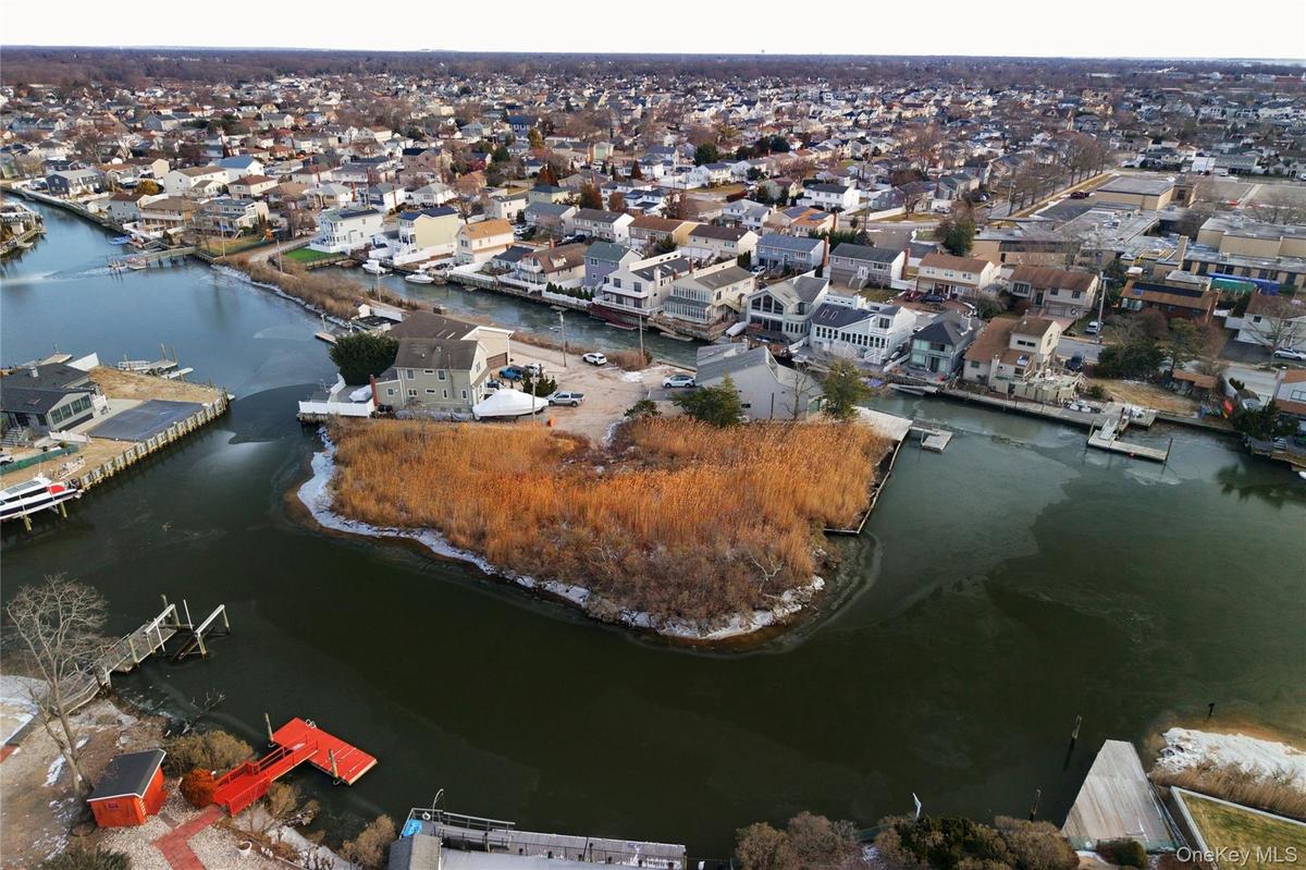 View of property location featuring a large body of water and nearby suburban area