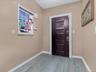 Foyer entrance featuring baseboards and wood finished floors