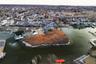 Aerial view of property's location with a nearby body of water and nearby suburban area