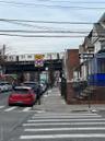 View of asphalt street featuring sidewalks and curbs