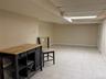 Finished below grade area featuring a paneled ceiling and baseboards